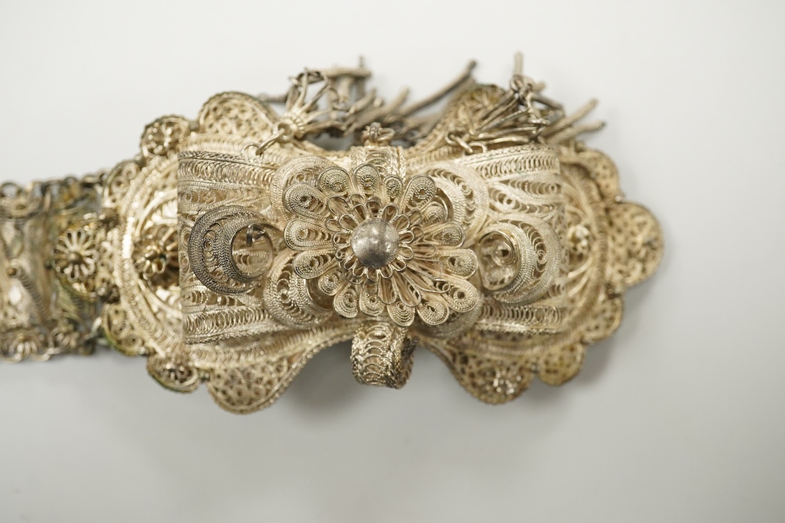 An Indian white metal filigree belt, 86cm.